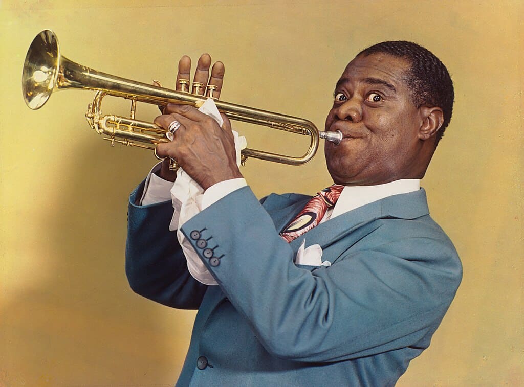 Jazz musician Louis Armstrong playing his trumpet